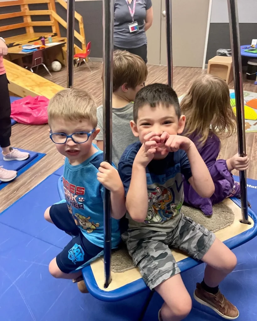 Children playing on a swing at PediaPlex